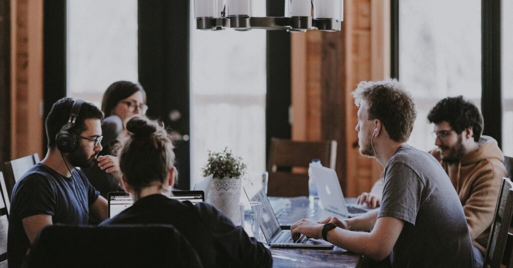Conversation between workers on a team. They are considering how to alter their communication style in the workplace.